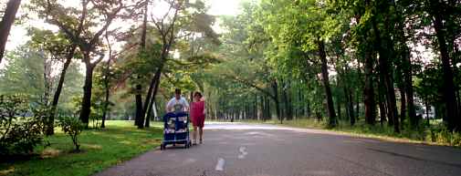 couple with stroller in park
